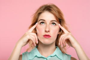 woman pressing her temples