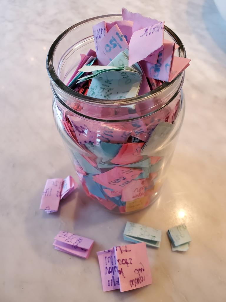 Gratitude Jar filled with slips of paper marking memorable moments throughout the year