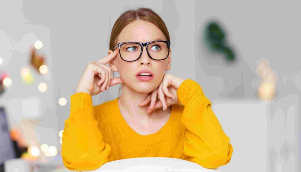 woman with glasses looking confused and unsure
