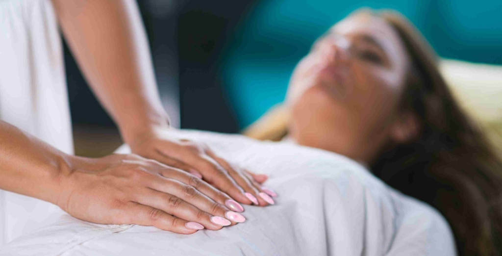 close up of woman receiving a reiki session