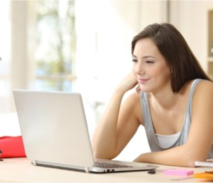 Woman smiling looking at laptop