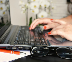 Close up of fingers typing on laptop