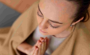 woman praying and showing gratitude