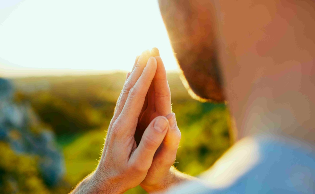 close up of man's hands in prayer