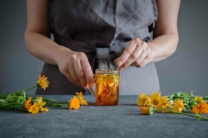 woman making herbal medicine with calendula