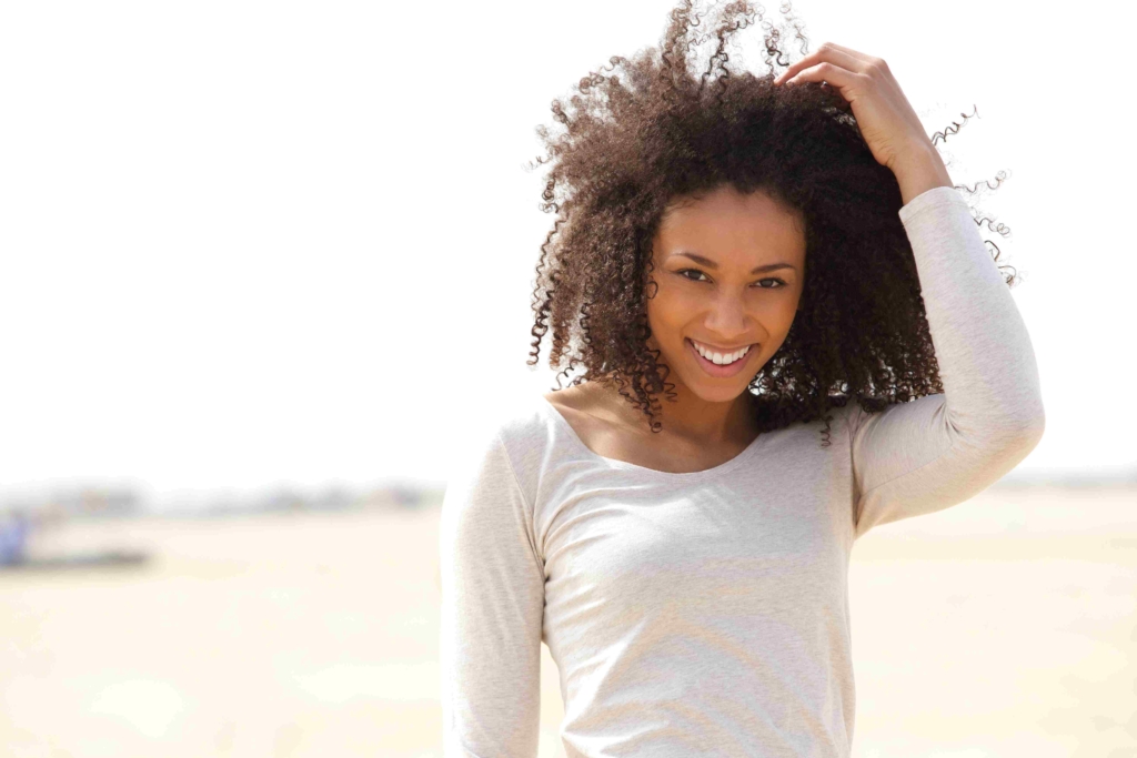 woman smiling after using hypnotherapy and distance reiki to transform fear of public speaking and ablocked throat chakra